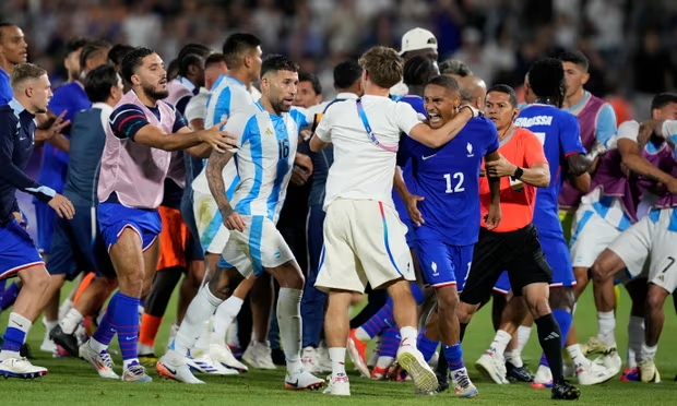 France and Argentina players have to be separated after the final whistle. Photograph: Moisés Castillo/AP (Image obtained at theguardian.com)