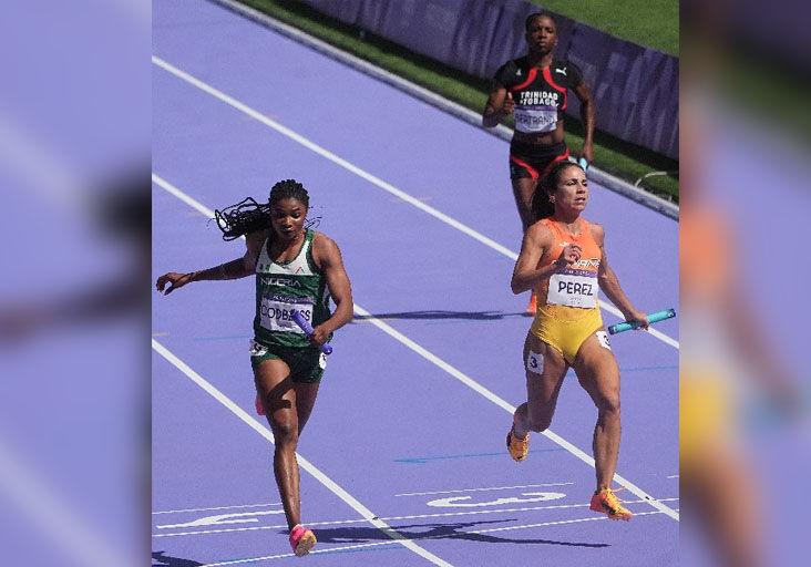 TTO ANCHOR: Leah Bertrand, top right, performs anchorleg duties for Trinidad and Tobago in the second women’s 4x100 metres qualifying round heat at the Stade de France, in Paris, yesterday. T&T finished eighth in the race in 43.99 seconds, and did not progress to the final. Also in the photo are Nigeria’s Tima Godbless, left, and Spain’s Maria Perez. Nigeria and Spain were sixth and seventh, respectively, clocking 42.70 and 42.77. —Photo: BRENT STUBBS (Image obtained at trinidadexpress.com)