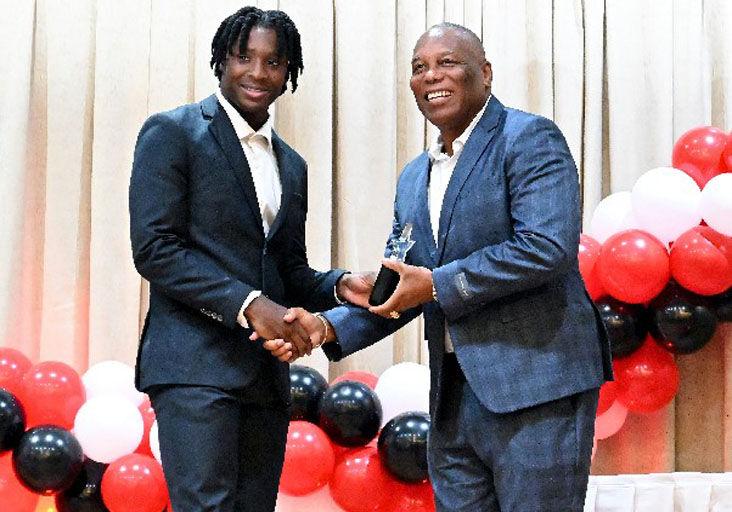 ‘WELL DONE’: Ephraim Serrette, President of the National Association of Athletics Administrations of Trinidad and Tobago (NAAATT), right, presents Kadeem Chinapoo with the President’s Rising Star award, during the NAAATT’s Annual Awards Ceremony, at the Radisson Hotel, Port of Spain, on Saturday night. —Photo: ISHMAEL SALANDY (Image obtained at trinidadexpress.com)